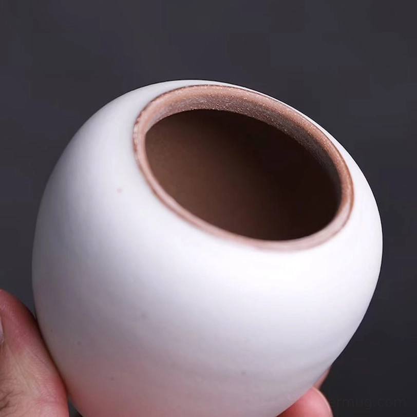 open white ceramic tea canister showing interior