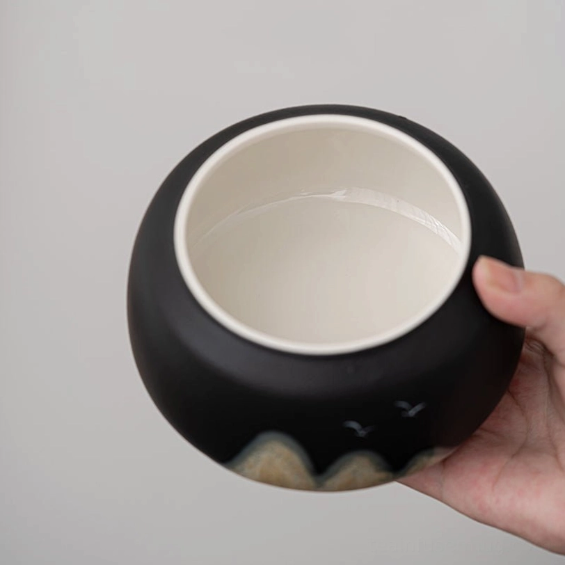 open ceramic tea storage canister showing inner seal
