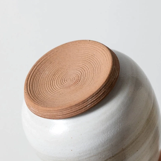 open ceramic tea storage canister showing inner seal lid design