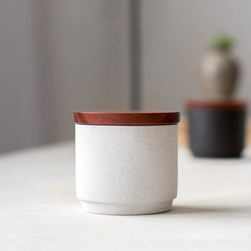Top view of open white matte ceramic tea storage canister