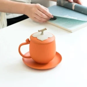 full set of orange persimmon ceramic tea infuser mug with lid, infuser and saucer