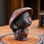 ceramic pee boy tea pet with child hat tea strainer front view