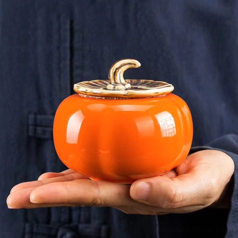 persimmon shape ceramic tea storage caddy held in palm