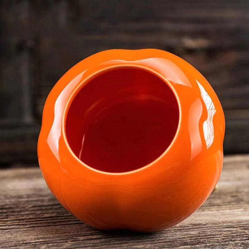 top view of persimmon shaped ceramic tea storage caddy showing stem lid