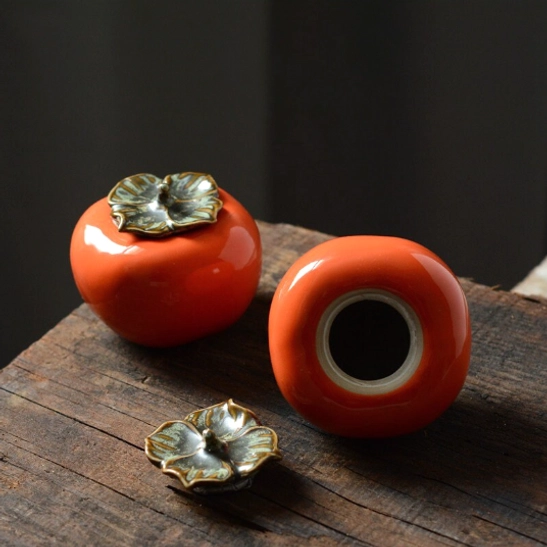 Bottom view of persimmon ceramic tea storage canister showing opening