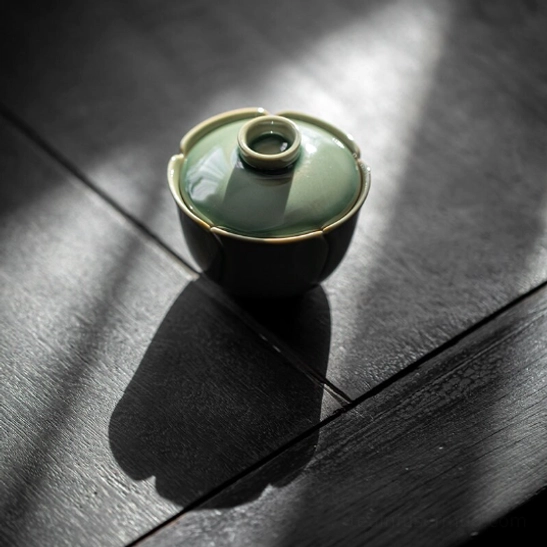 Close up of celadon glaze texture on petal gaiwan tea cup