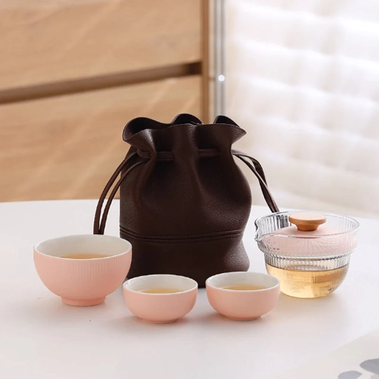 pink travel tea set with glass gaiwan and three pink ceramic cups
