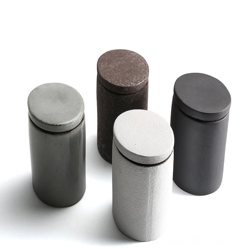 pouring loose leaf tea from opened ceramic tea storage canister