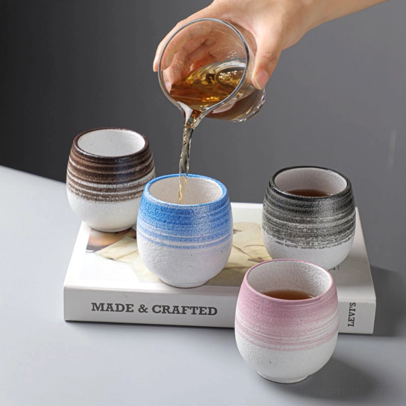 pouring hot tea into a rustic japanese ceramic tea cup