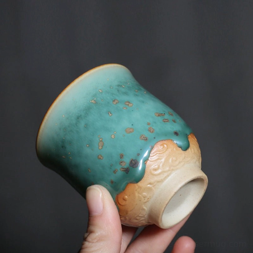 pouring tea into green glazed porcelain teacup 120ml