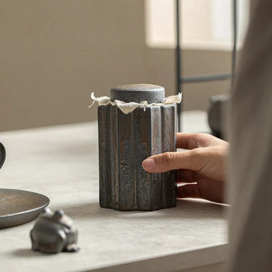 profile view of fluted ceramic tea canister showing shape and glaze