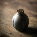 Full view of retro dark gray ceramic tea storage canister with cork lid