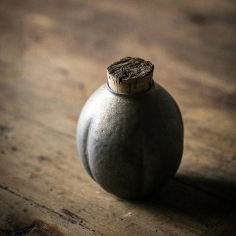 Full view of retro dark gray ceramic tea storage canister with cork lid