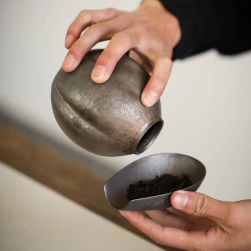 Retro tea storage canister displayed on a wooden table