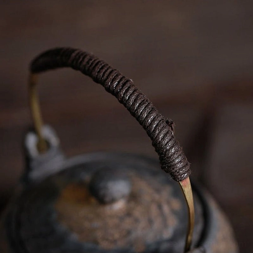 close up of the hammered textured surface on the rough ceramic teapot body