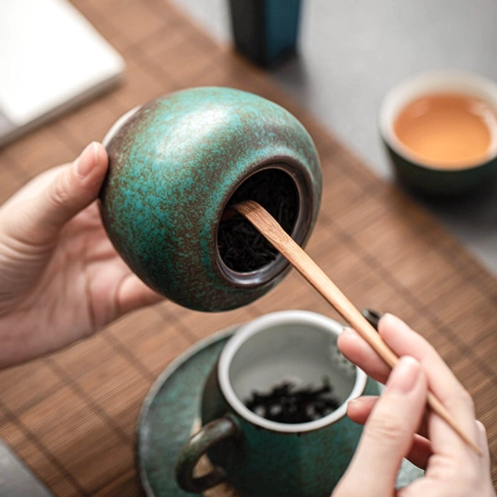 rounded 300ml airtight tea canister held by hand to show size