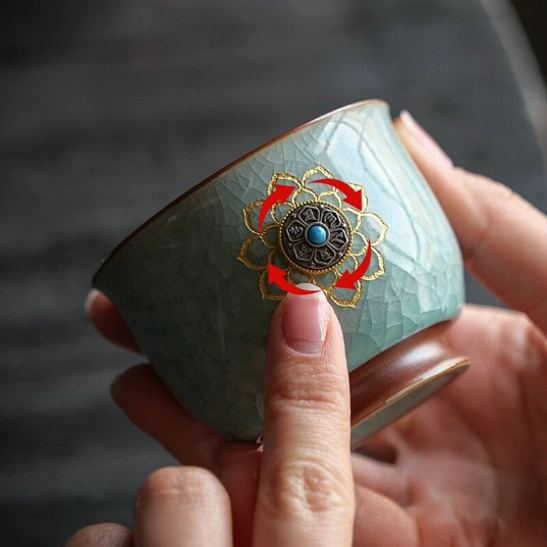 close up of rotating decorative center on ru kiln lotus chinese tea cup