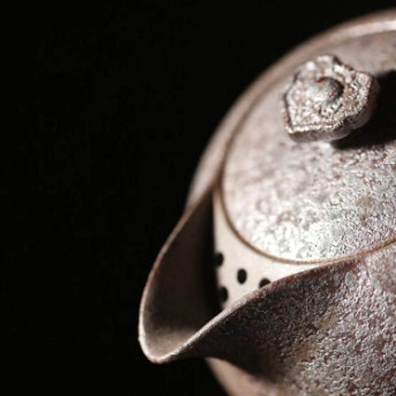 close up of textured rust glaze on ceramic teapot surface