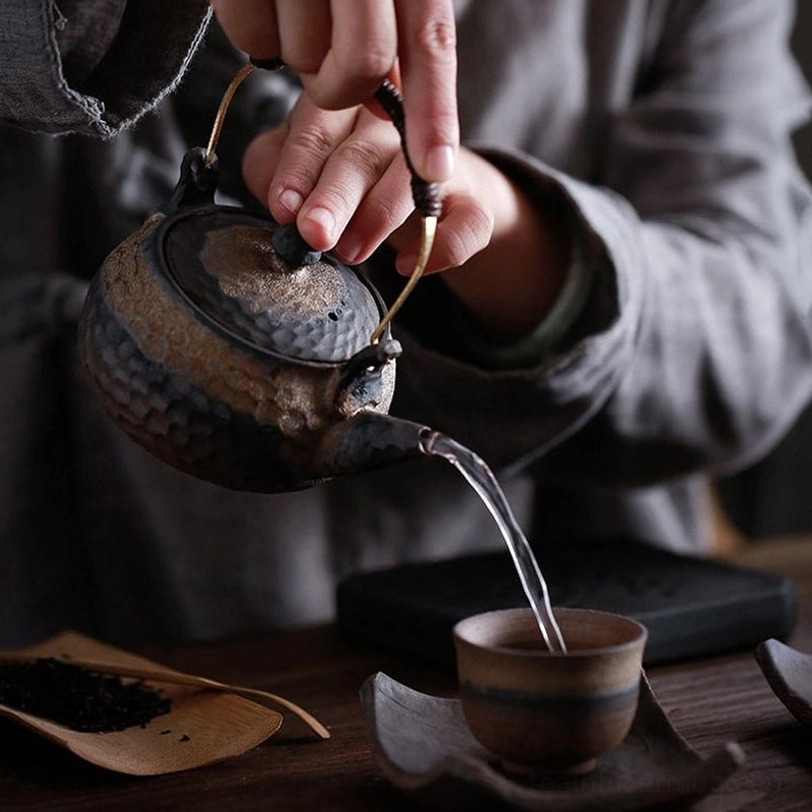 this rustic ceramic teapot with infuser styled on a traditional tea table