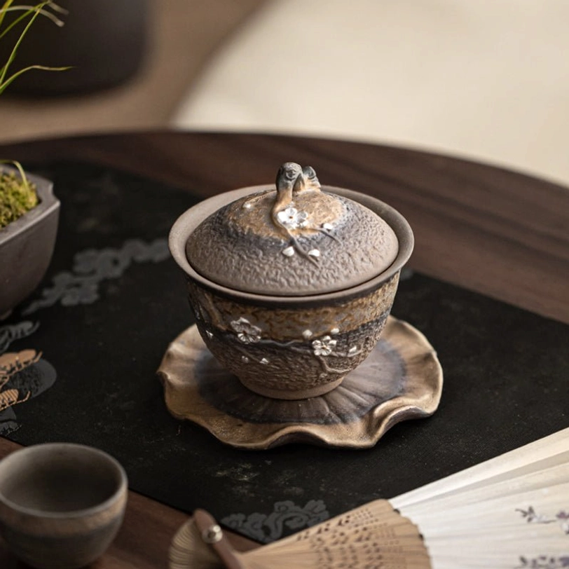Rustic ceramic texture detail on plum blossom gaiwan tea cup body