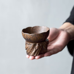 full view of handcrafted rustic ceramic tea strainer with tree stump stand