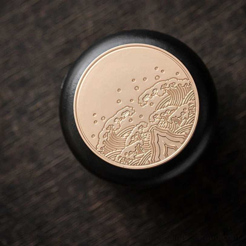 top view of sealed metal lid on black ceramic tea storage caddy