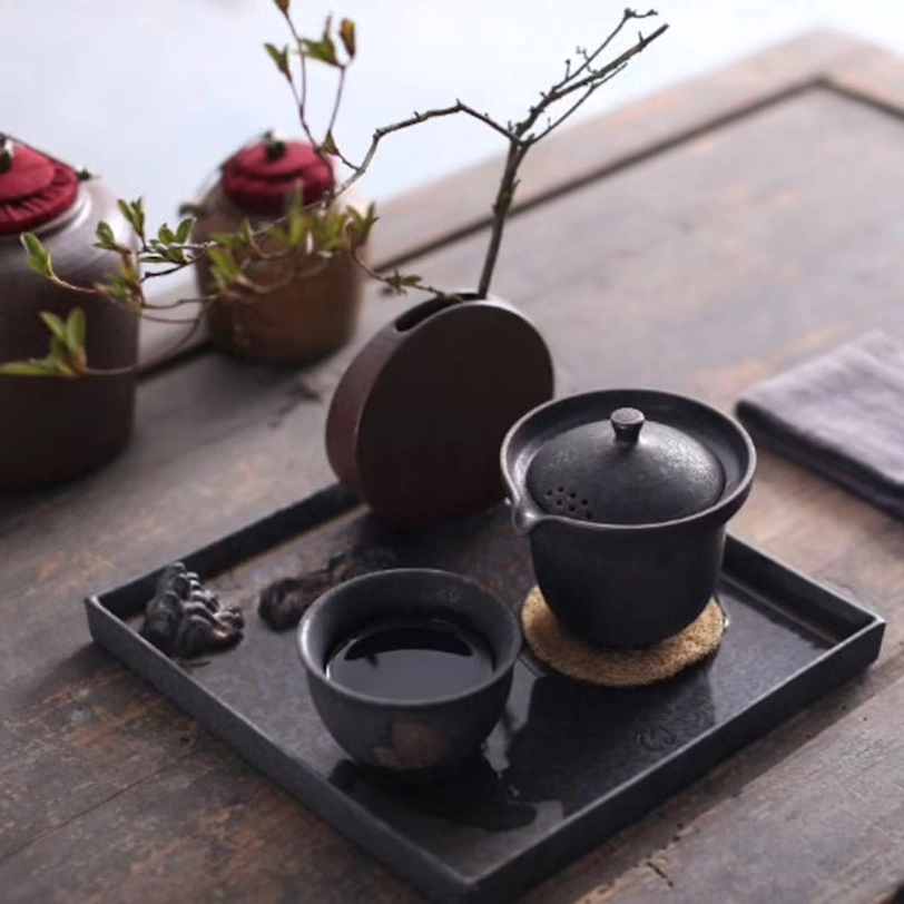 Separated teapot and teacup of rustic travel tea set