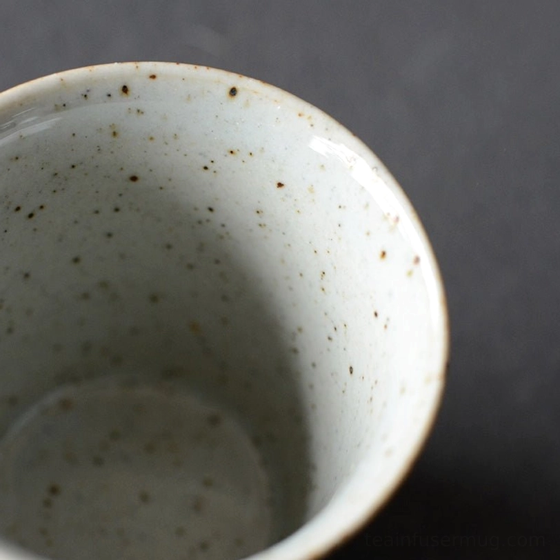 side profile of matte black japanese tea cup showing tapered shape