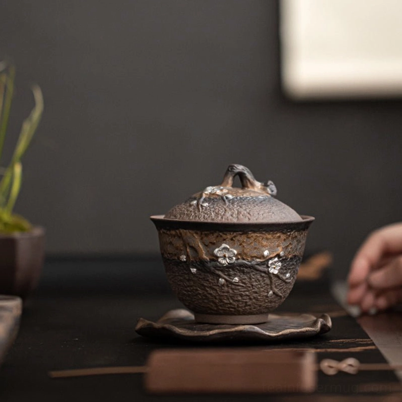 Side view of 200ml plum blossom ceramic gaiwan tea cup on lotus saucer