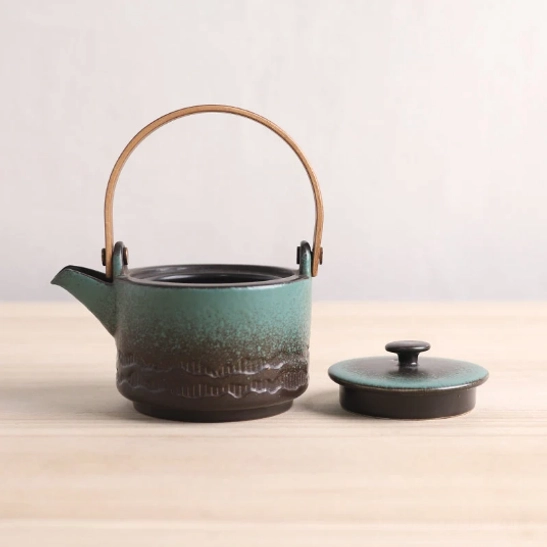 side angle view of 200ml ceramic teapot with wooden handle and removable infuser