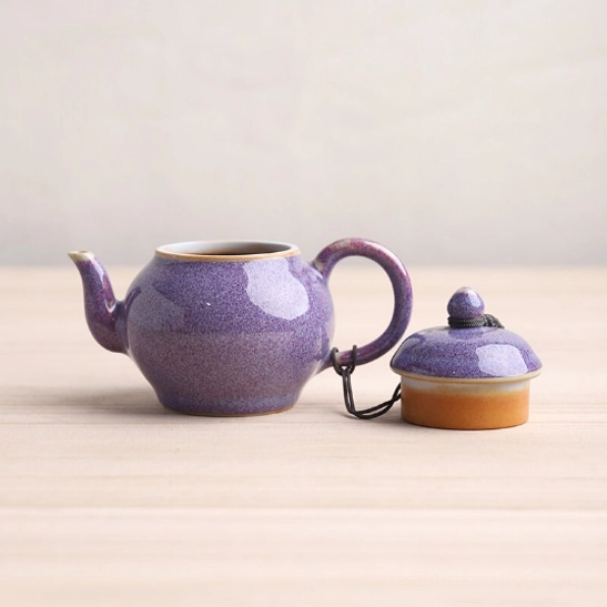Side view of 110ml Chinese ceramic teapot with infuser showing curved shape