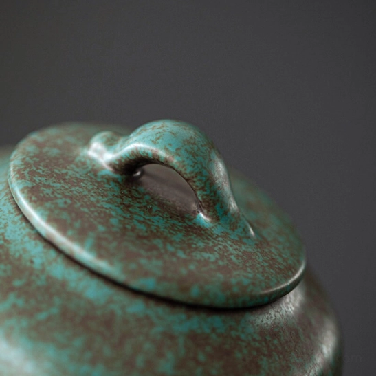 side view of gradient blue green brown ceramic tea storage canister