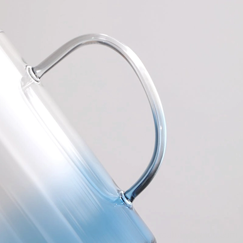 side view of gradient blue mountain glass tea infuser mug with black infuser