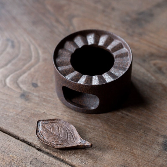 side view of ceramic kyusu teapot with branch handle and candle warmer base