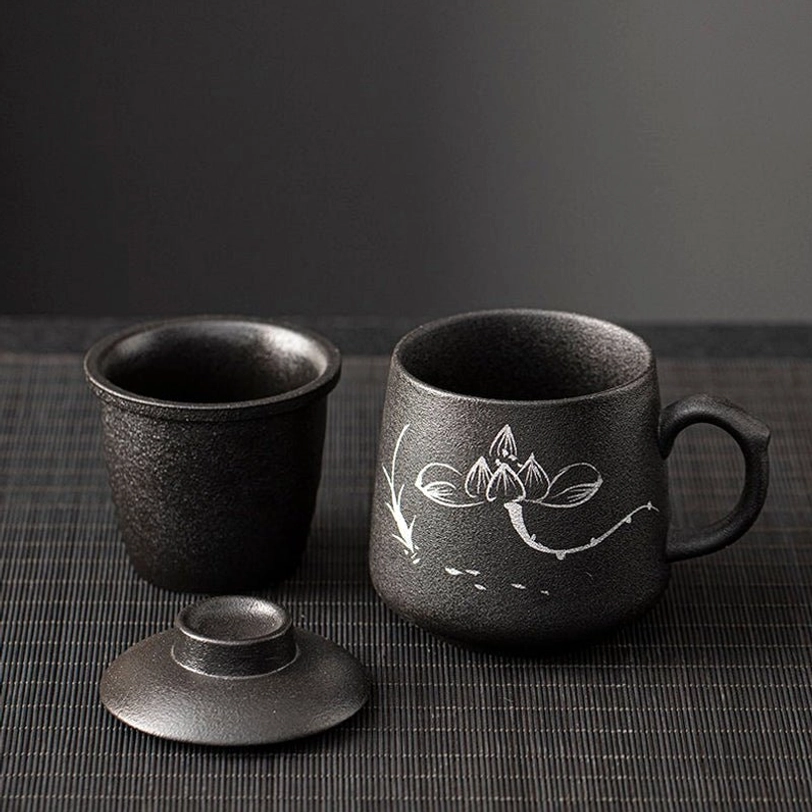 side view of matte black chinese art ceramic tea infuser mug with heat-resistant handle