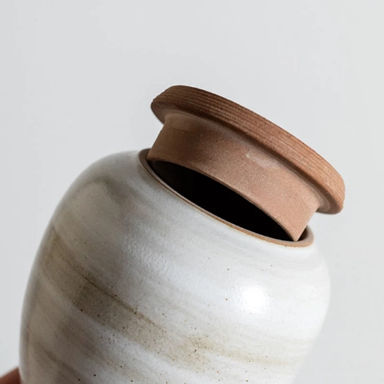 side view of sealed compact ceramic tea storage canister