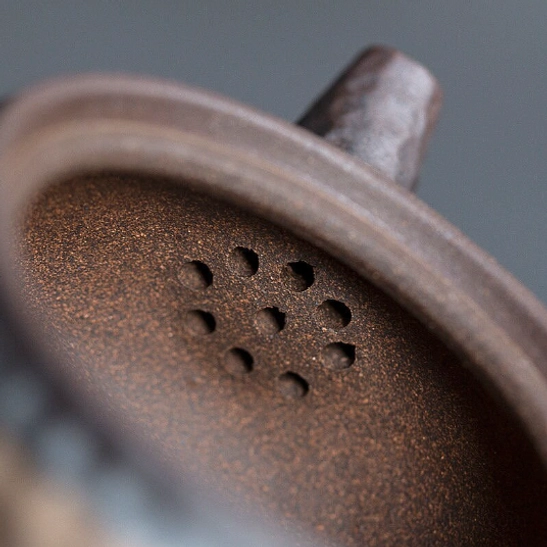 side view of vintage japanese clay teapot showing ergonomic side handle