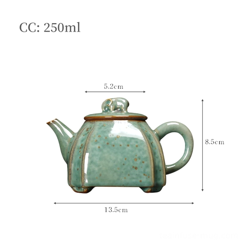 side profile of green speckled ceramic teapot with elephant finial