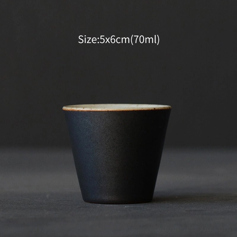 single black japanese tea cup showing speckled white inner glaze