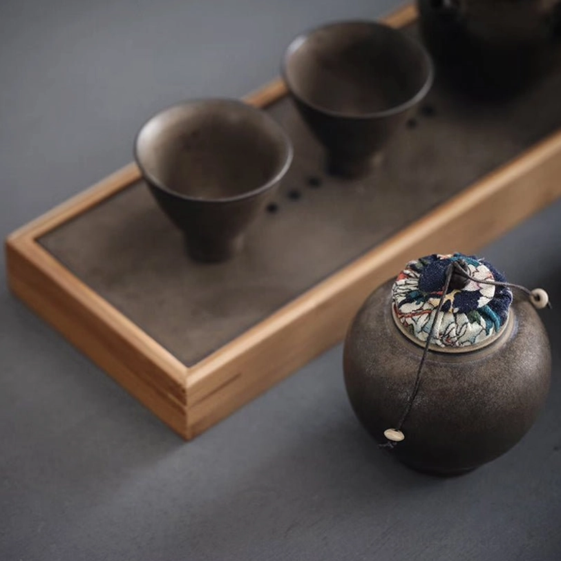 size comparison of dark ceramic tea storage canister