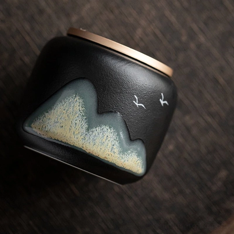 small ceramic tea storage canister held in hand to show size