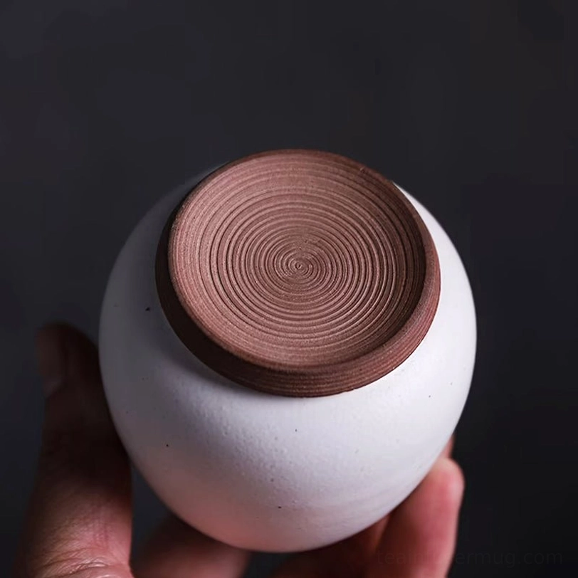 side profile of speckled white ceramic tea storage jar