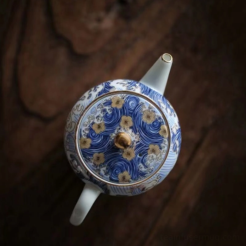 side view of blue ocean pattern gongfu teapot with gold flower accent