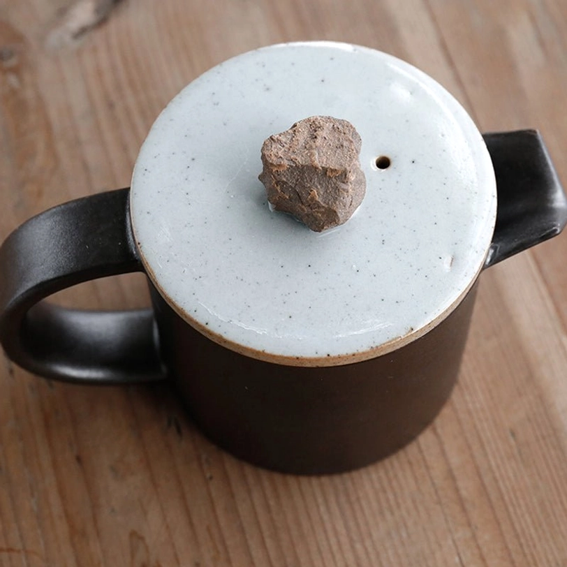 top view of stone lid knob on side handle teapot with infuser