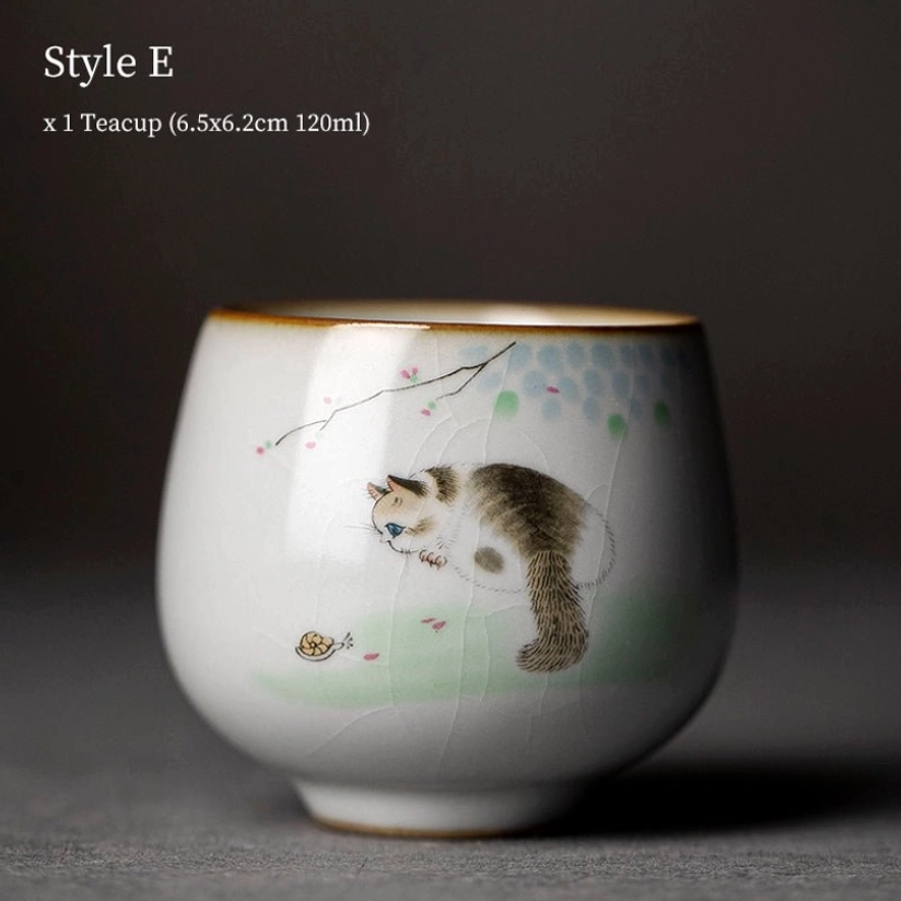 style e cat motif chinese ceramic tea cup held in hand to show size