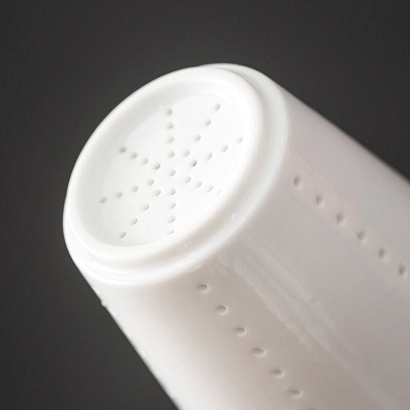 removable tea filter resting on the lid of ceramic tea infuser mug