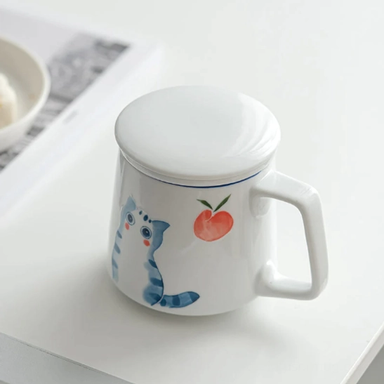 ceramic tea infuser placed inside the cat peach ceramic tea mug