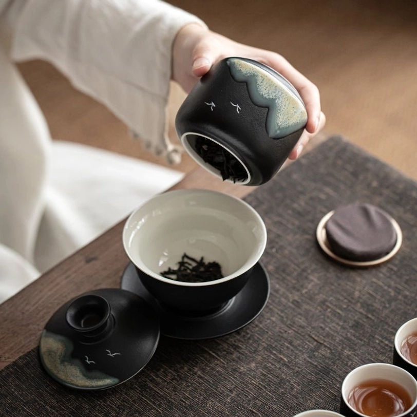 ceramic tea storage canister styled on traditional tea table with other tea ware