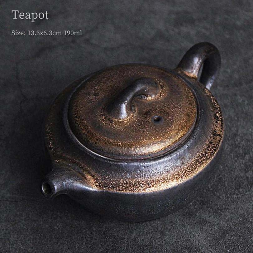 textured gilded finish on rustic ceramic teapot with infuser