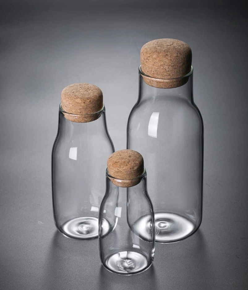 three sizes of glass tea storage canisters arranged together